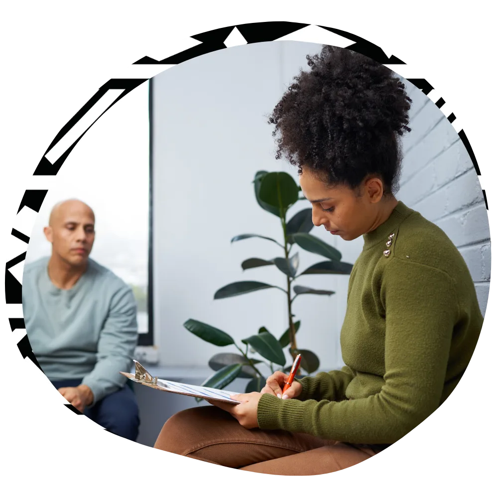 Counsellor taking notes in counselling session