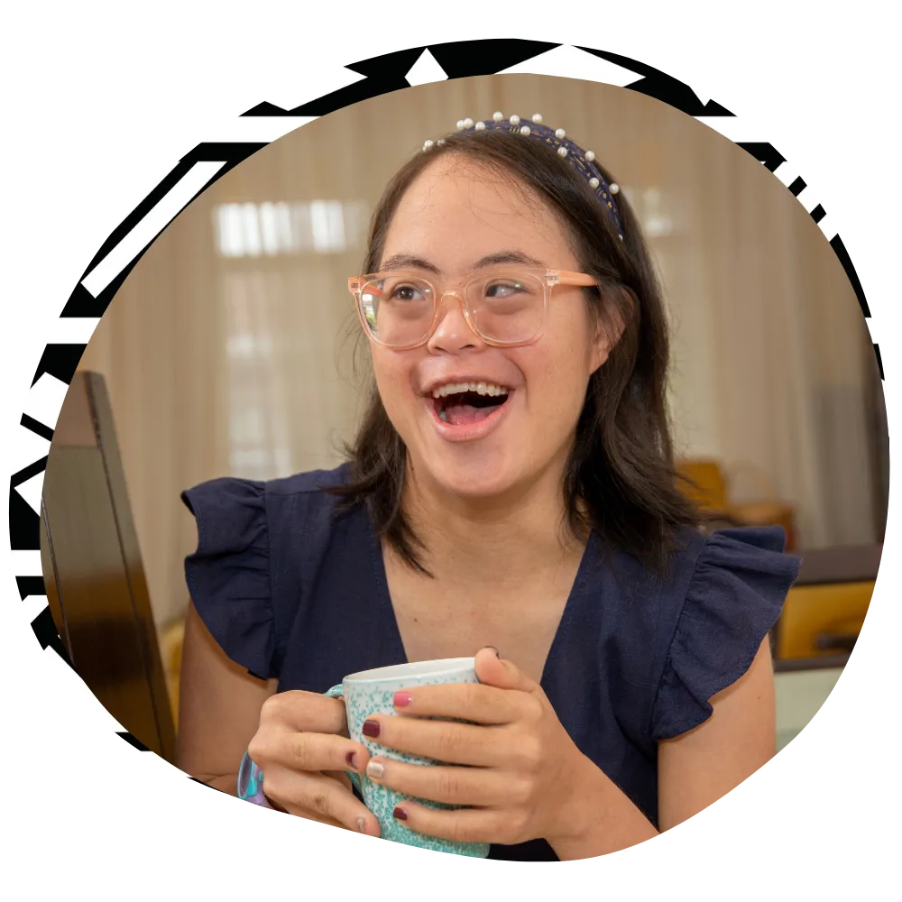 Disabled woman at home smiling while holding mug