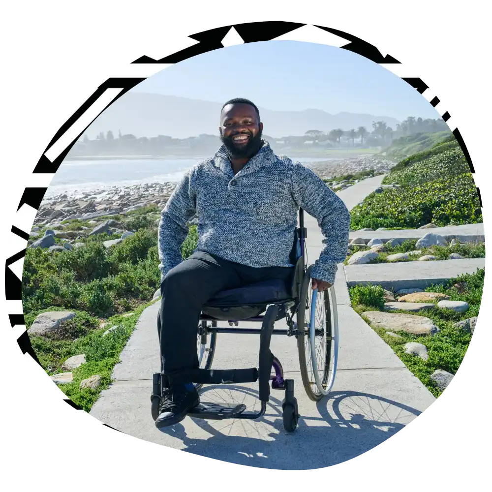 Disabled man in wheelchair smiling at camera