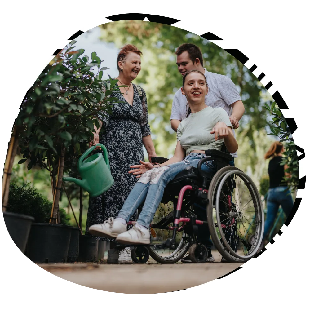 Support worker with two disabled friends all smiling